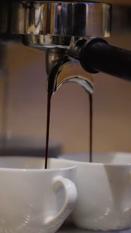 Reel: espresso, steamed milk and latte art, carried to a table in the restaurant