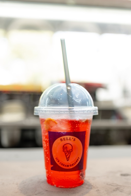 A red mojito in a domed Bell’s cup, the counter blurred behind