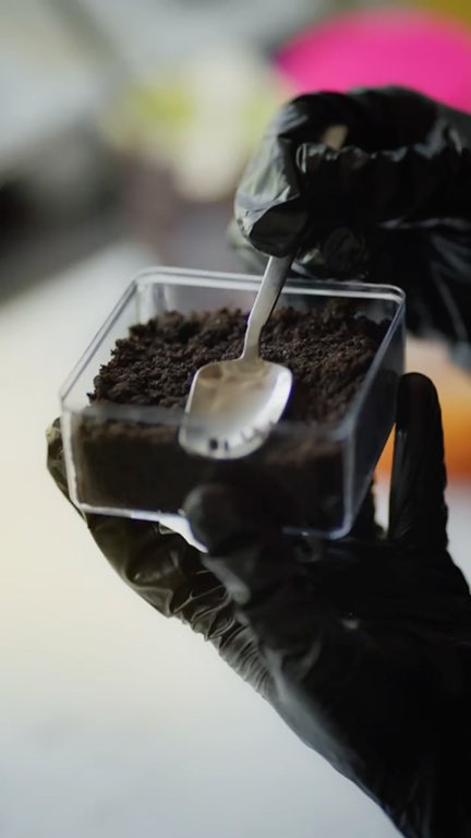 Reel: gloved hands building a kunafa brownie with pistachio cream