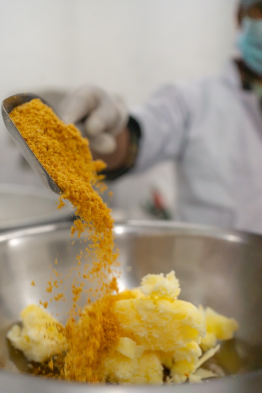 Millet flour poured into a bowl of butter during production at Mierra