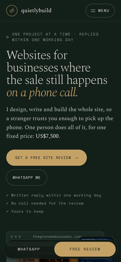 The old design of quietlybuild.in, the first screen on a phone: a dark green page with gold type, two buttons in small capitals, and the first client’s site just starting under the WhatsApp bar.