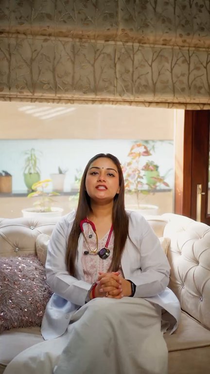 Dr Bedi in a white coat on a white sofa by a bright window, the question ‘What is protein?’ on screen